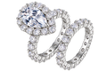 The Pear Halo Set: 7 × 11 mm pear moissanite in a halo with a matching pavé eternity band — sterling silver two-ring set