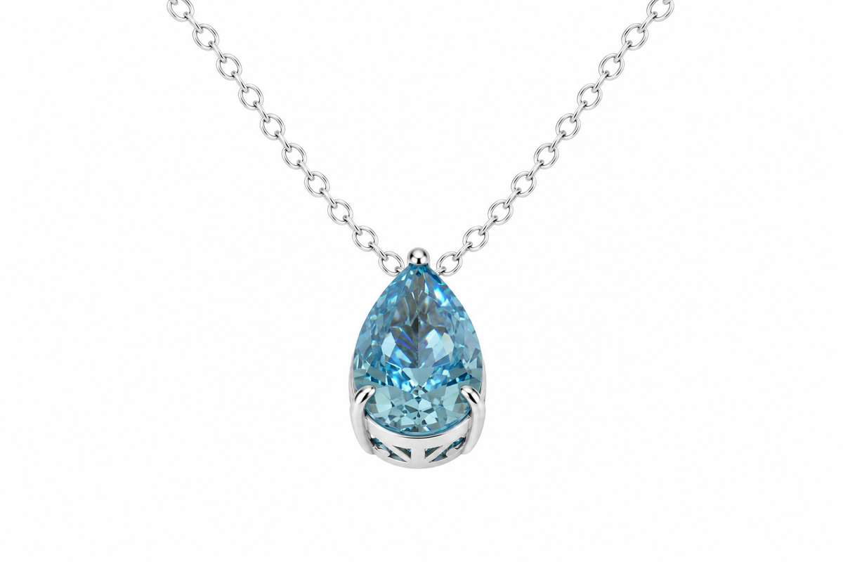 Silver-tone necklace with light blue pear-cut cubic zirconia pendant on white