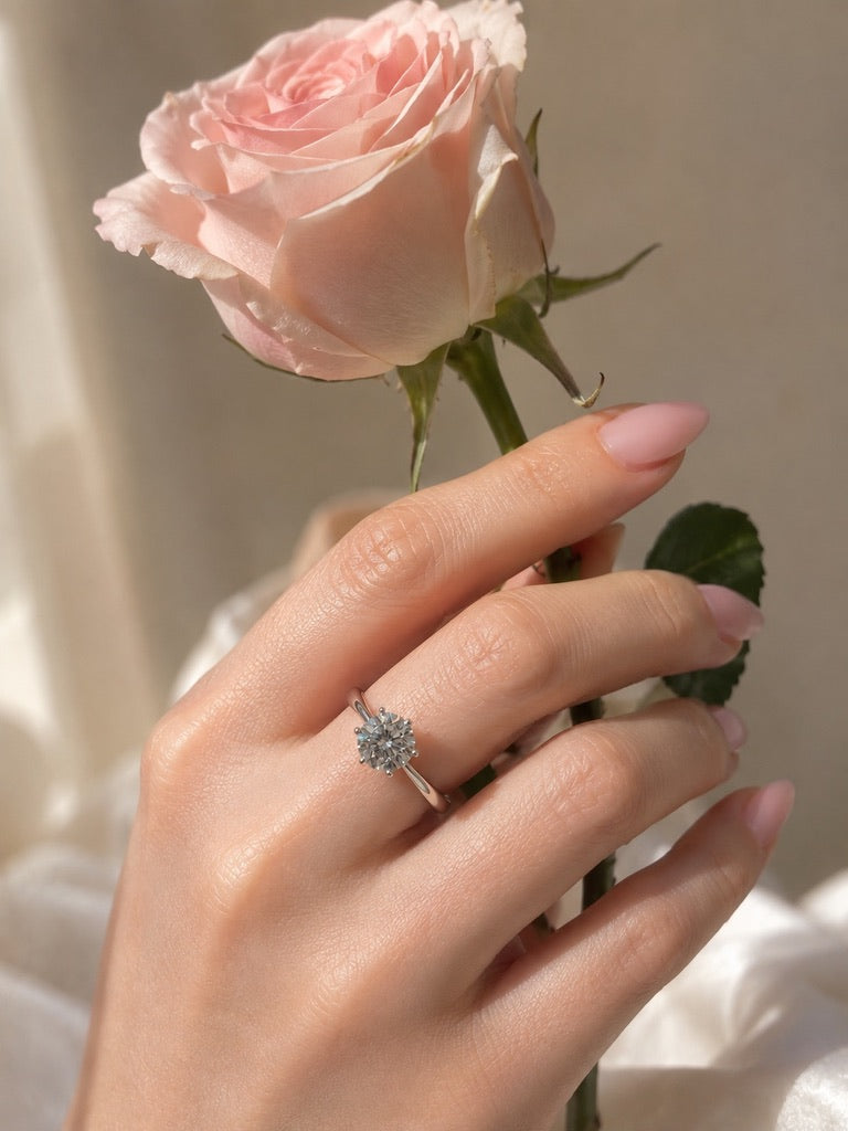 Silver-tone cubic zirconia solitaire ring worn on hand