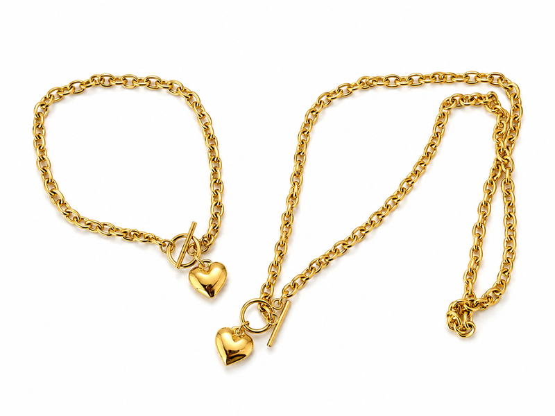 Gold-tone heart necklace and bracelet set on white background