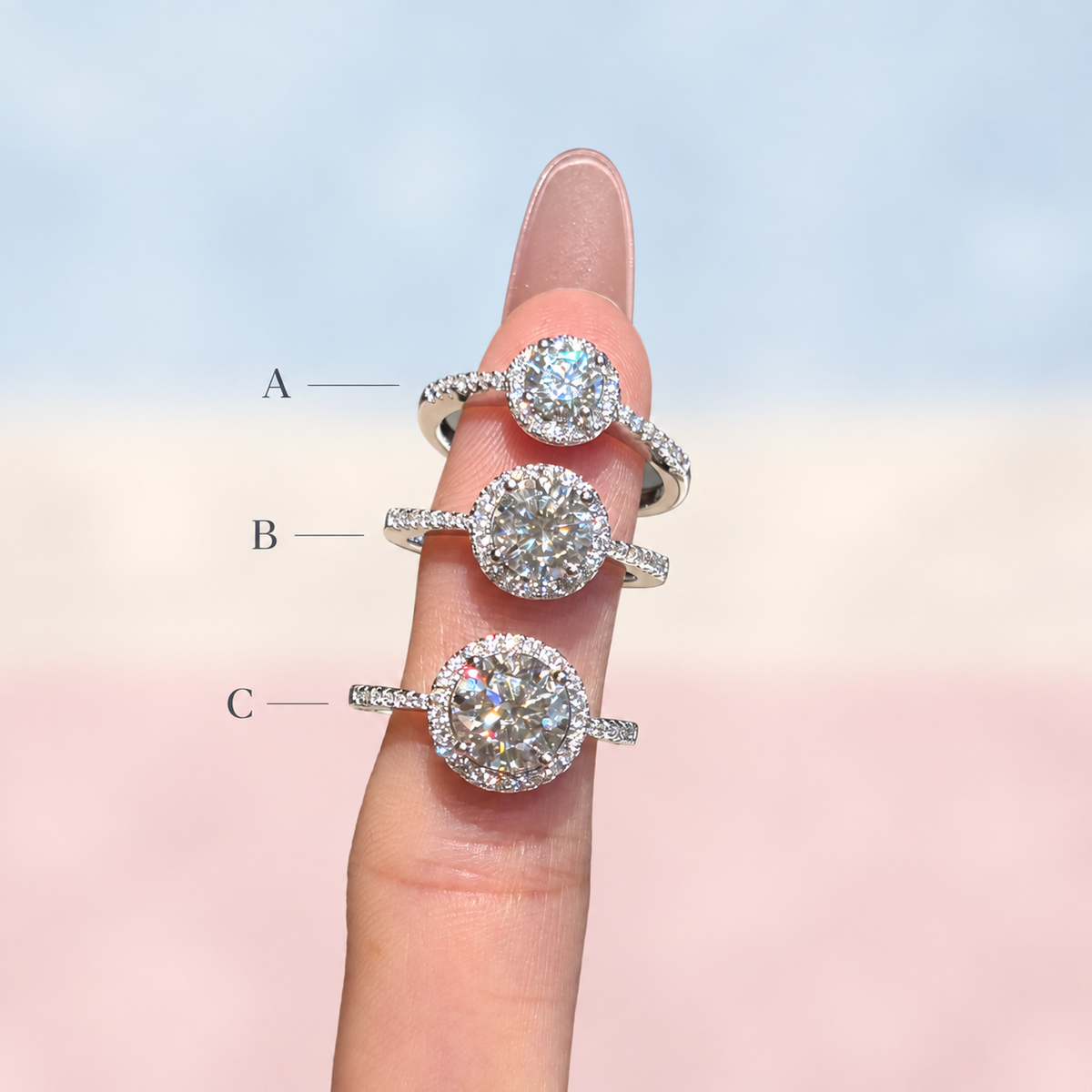 Three halo rings stacked on one finger labelled A, B and C, comparing the 5, 6.5 and 8 mm centre stones