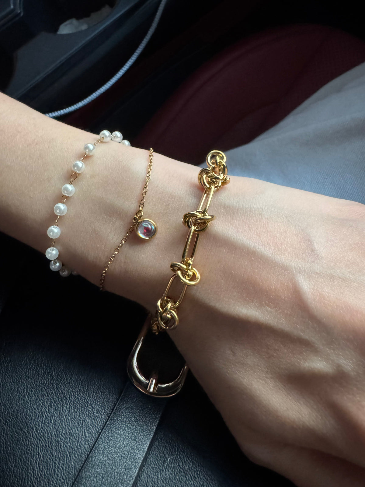Faux-pearl charm bracelet layered with a gold-tone Knot Link bracelet
