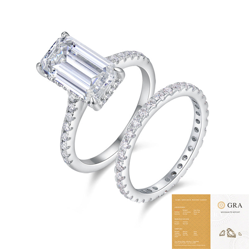 The Emerald Pavé Set: 7 × 12 mm emerald-cut moissanite on a pavé shank with a matching pavé band — sterling silver two-ring set