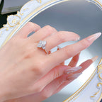 Sterling silver marquise moissanite ring on a hand, angled to catch the light