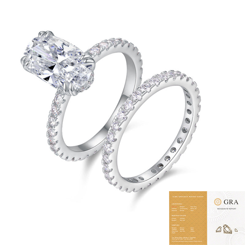 The Oval Pavé Set: 8 × 12 mm oval moissanite on a pavé shank with a matching pavé eternity band — sterling silver two-ring set