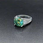 Emerald green round-cut moissanite ring in S925 sterling silver, angled view