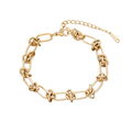 Gold-tone bracelet with alternating oval links and knot details