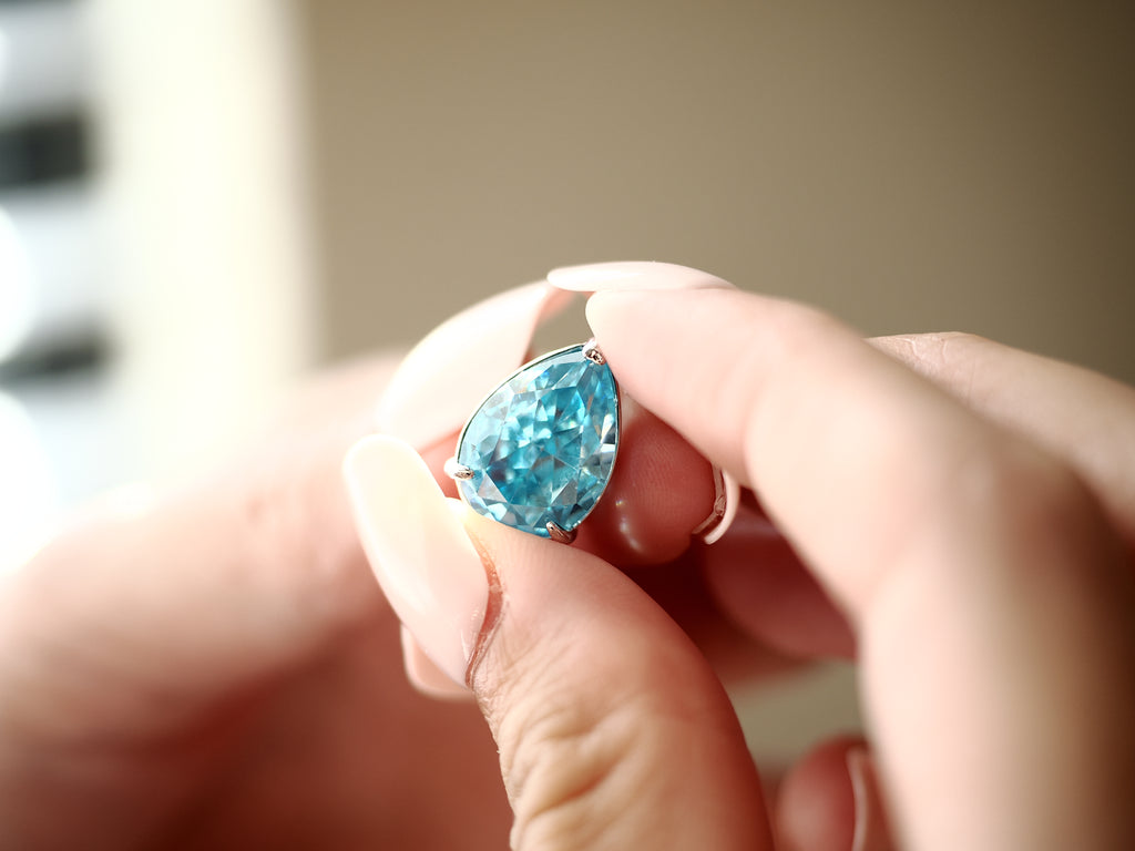 Pale blue pear-cut cubic zirconia pendant shown in close-up